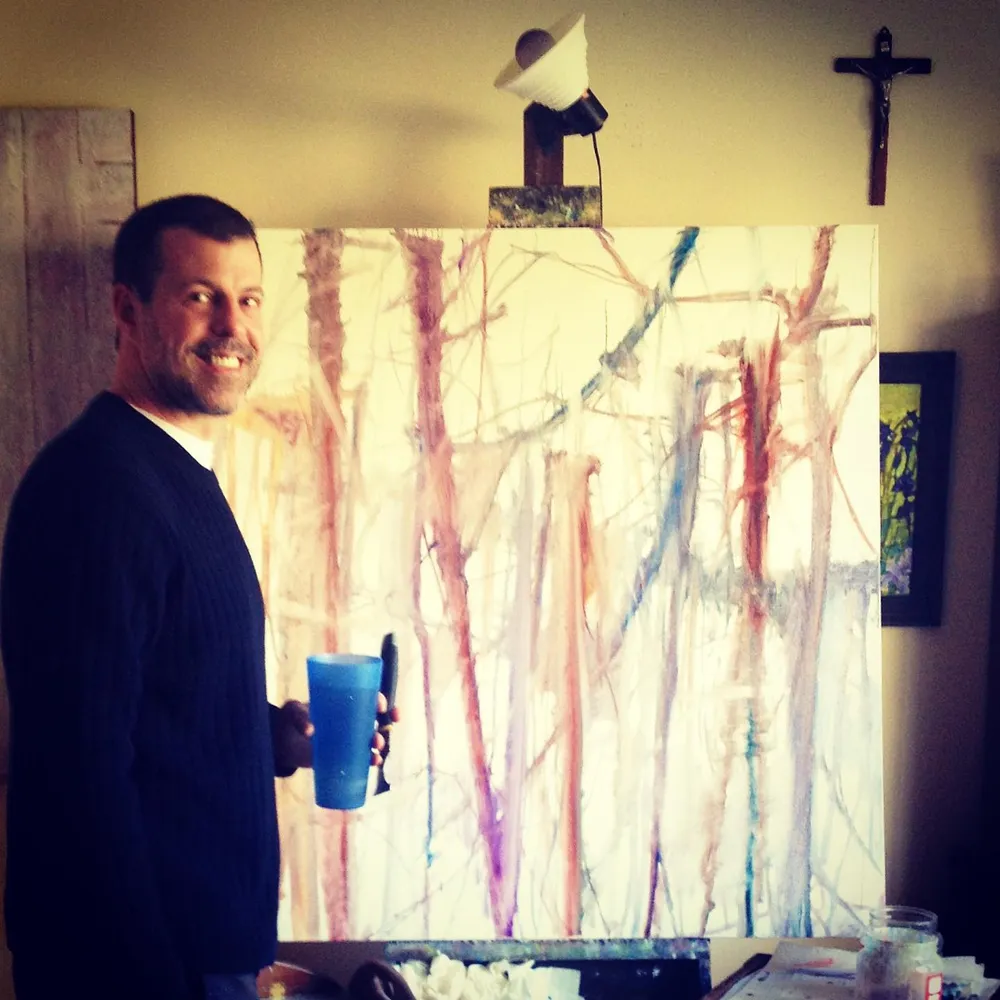 Alan Robinson in his studio with large-scale oil canvases