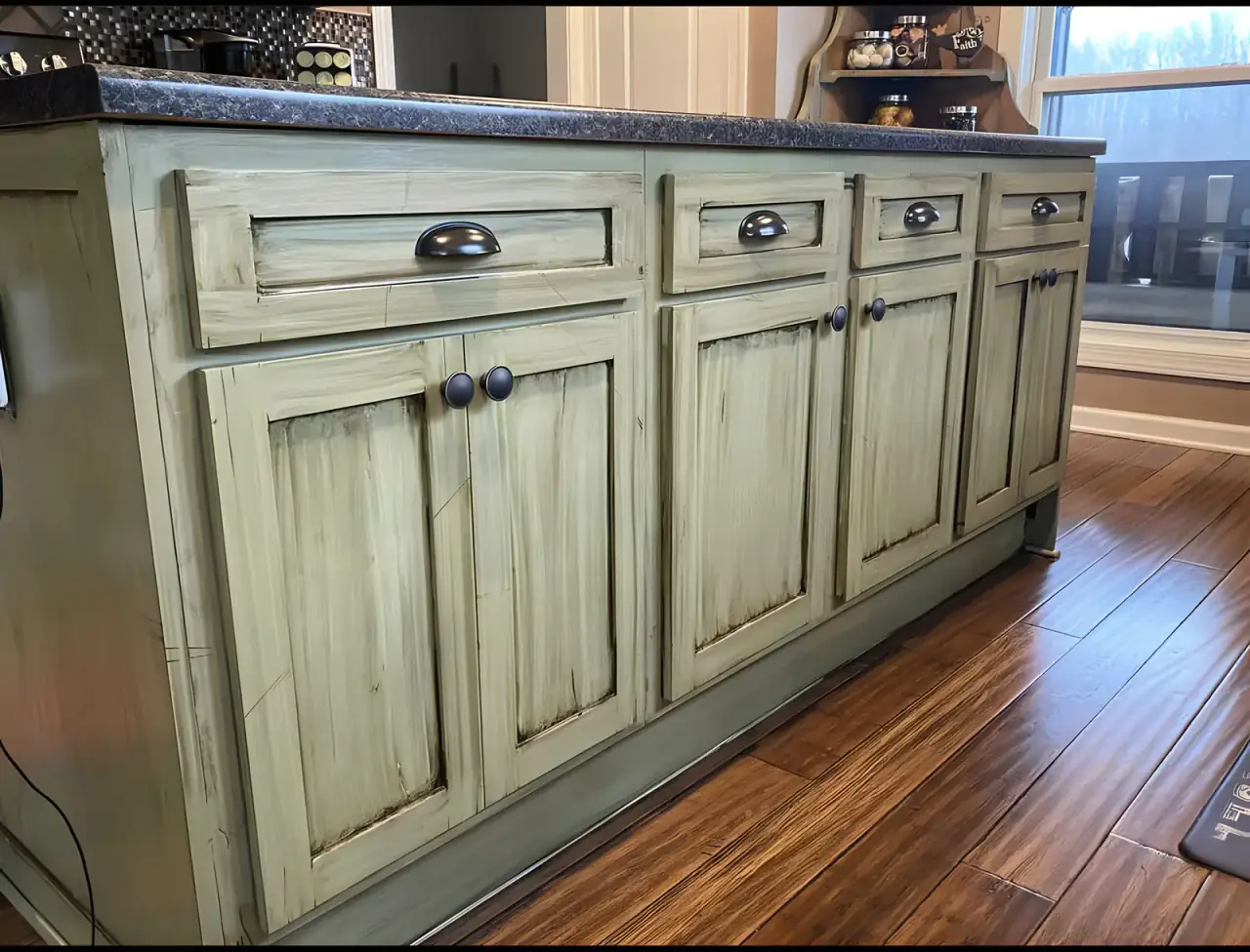 Kitchen island cabinetry painted and hand-glazed for a rustic finish, one of our cabinet painting projects for Bellevue homes